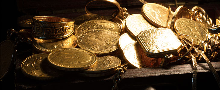 gold coins and jewellery representing buying and selling gold