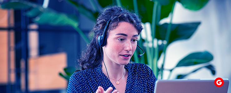 A trader in front of her laptop, highlighting the key concept of portfolio diversification in trading.