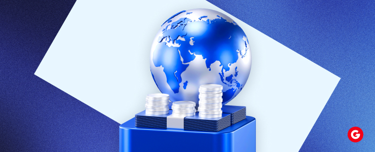 A blue globe topped with various coins, symbolizing global finance and economic exchange.